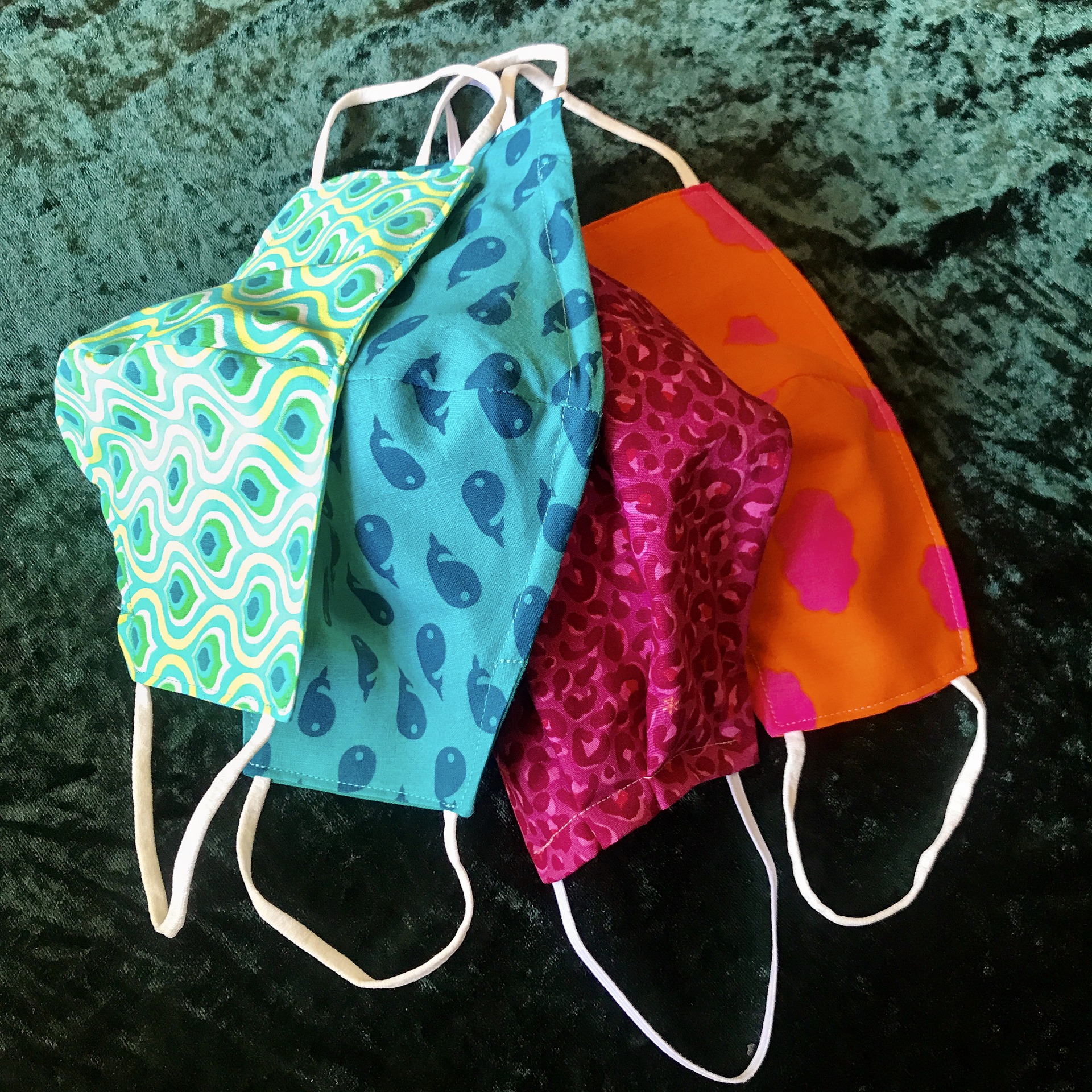 Photo of four fabric face masks hanging down